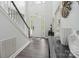 Bright foyer with hardwood floors, a staircase, and a view of the front door at 9954 Mitchell Glen Dr, Charlotte, NC 28277