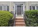 Inviting front entrance with a brick walkway and meticulously landscaped bushes at 9954 Mitchell Glen Dr, Charlotte, NC 28277