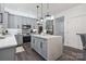 Spacious kitchen with gray cabinetry, center island and stainless steel appliances at 9954 Mitchell Glen Dr, Charlotte, NC 28277