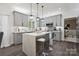 Stylish kitchen with a center island, gray cabinets, and modern pendant lighting fixtures at 9954 Mitchell Glen Dr, Charlotte, NC 28277