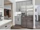 Sleek kitchen with stainless steel refrigerator, gray cabinets, and a view to the living room at 9954 Mitchell Glen Dr, Charlotte, NC 28277