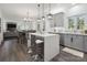 Open-concept kitchen with an island, gray cabinetry, hardwood floors and modern lighting at 9954 Mitchell Glen Dr, Charlotte, NC 28277