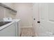Functional laundry room with tile flooring, shelving, and washer and dryer at 9954 Mitchell Glen Dr, Charlotte, NC 28277