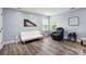 Comfortable living room featuring a sofa, recliner, hardwood floors and neutral paint at 9954 Mitchell Glen Dr, Charlotte, NC 28277