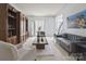 Cozy living room with a gray sofa, hardwood cabinets, and natural light at 9954 Mitchell Glen Dr, Charlotte, NC 28277