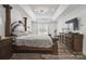 Main bedroom features tray ceiling, dark wood floors, and an abundance of storage at 9954 Mitchell Glen Dr, Charlotte, NC 28277