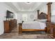 Large main bedroom features tray ceiling, dark wood floors, and ample space at 9954 Mitchell Glen Dr, Charlotte, NC 28277