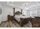 Spacious main bedroom with a tray ceiling, dark wood furniture, and a serene ambiance at 9954 Mitchell Glen Dr, Charlotte, NC 28277