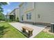 Exterior view of a fenced backyard, concrete patio, and a stone bench at 10009 Community House Rd, Charlotte, NC 28277
