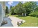 Spacious backyard with mature trees, shed and concrete patio at 10009 Community House Rd, Charlotte, NC 28277