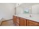 Bathroom with double sink vanity and wood-look tile flooring at 10009 Community House Rd, Charlotte, NC 28277
