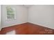 Cozy bedroom with a large window and hardwood floors at 10009 Community House Rd, Charlotte, NC 28277