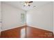 Empty bedroom features hardwood floors, a window and ceiling fan at 10009 Community House Rd, Charlotte, NC 28277