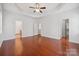 Spacious bedroom with hardwood floors, tray ceiling, and walk-in closet at 10009 Community House Rd, Charlotte, NC 28277