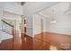 Open-concept dining room with hardwood floors, bright lighting, and staircase at 10009 Community House Rd, Charlotte, NC 28277