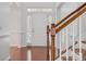 Bright entryway featuring hardwood floors, staircase, and white door with sidelights at 10009 Community House Rd, Charlotte, NC 28277