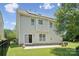 Two-story home featuring solar panels, fenced yard, and a back patio at 10009 Community House Rd, Charlotte, NC 28277