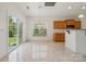 Bright eat-in kitchen features sliding glass doors, natural light, tile floors, and wooden cabinetry at 10009 Community House Rd, Charlotte, NC 28277