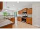 Well-lit kitchen with granite counters, stainless steel oven, and wooden cabinets at 10009 Community House Rd, Charlotte, NC 28277