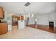 Open kitchen and living area with stainless steel appliances, bar seating, and modern lighting at 10009 Community House Rd, Charlotte, NC 28277