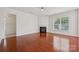 Bright living room with hardwood floors, a modern fireplace, and a large window at 10009 Community House Rd, Charlotte, NC 28277