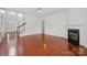 Spacious living room with hardwood floors, natural light, and a cozy fireplace at 10009 Community House Rd, Charlotte, NC 28277