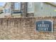 Ardrey Court community sign on a brick wall with homes in the background at 10009 Community House Rd, Charlotte, NC 28277