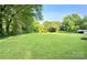 Expansive backyard with lush green grass and mature trees, perfect for outdoor activities at 114 Huffstetler Rd, Gastonia, NC 28056