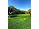 Enjoy the open backyard with a covered metal structure, lush green grass and beautiful trees at 114 Huffstetler Rd, Gastonia, NC 28056