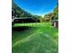 Enjoy the open backyard with a covered metal structure, lush green grass and beautiful trees at 114 Huffstetler Rd, Gastonia, NC 28056