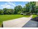 Large grassy backyard with mature trees, plus a convenient covered parking area for vehicles or equipment at 114 Huffstetler Rd, Gastonia, NC 28056