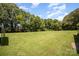 Expansive green backyard with mature trees, perfect for outdoor activities and enjoying nature's beauty at 114 Huffstetler Rd, Gastonia, NC 28056