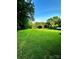 Lush green yard with mature trees, offering a secluded and picturesque view at 114 Huffstetler Rd, Gastonia, NC 28056
