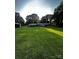 Large green backyard featuring a covered patio, offering ample space for relaxation and entertainment at 114 Huffstetler Rd, Gastonia, NC 28056