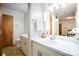 Bright bathroom featuring a white sink vanity and a wooden door at 114 Huffstetler Rd, Gastonia, NC 28056