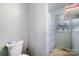 Bathroom with a white toilet and a shower with a blue patterned curtain at 114 Huffstetler Rd, Gastonia, NC 28056