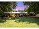 Charming one-story brick home features a lush green lawn and mature trees in a serene setting at 114 Huffstetler Rd, Gastonia, NC 28056