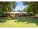 Charming brick home with a well-manicured lawn, mature trees and welcoming entrance at 114 Huffstetler Rd, Gastonia, NC 28056