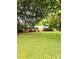 Charming brick home nestled on a lush, expansive green lawn with mature trees at 114 Huffstetler Rd, Gastonia, NC 28056