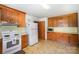 Well-lit kitchen featuring white appliances and ample cabinet space at 114 Huffstetler Rd, Gastonia, NC 28056