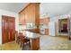Kitchen area with a dining table, wooden cabinets, and tile flooring at 114 Huffstetler Rd, Gastonia, NC 28056