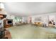 Spacious living room with sofas, fireplace, large windows, and access to bedrooms at 114 Huffstetler Rd, Gastonia, NC 28056