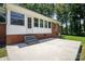 Rear view of home and patio showing a transition from the house to the outdoor area, with mature trees at 114 Huffstetler Rd, Gastonia, NC 28056