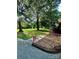 Inviting walkway with a vibrant floral welcome flag, leading to a lush front yard at 114 Huffstetler Rd, Gastonia, NC 28056