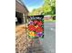 Welcome guests with this vibrant floral flag next to the brick-lined driveway at 114 Huffstetler Rd, Gastonia, NC 28056