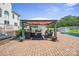 Spacious backyard featuring a large patio with outdoor lounge area, gazebo, a pool, and manicured landscaping at 12004 New Bond Dr, Huntersville, NC 28078