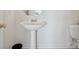 Clean, all white, half bath featuring a pedestal sink and toilet at 12004 New Bond Dr, Huntersville, NC 28078