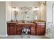 Primary bathroom with double sink vanity and decorative mirrors at 12004 New Bond Dr, Huntersville, NC 28078