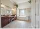 Large bathroom featuring double sink vanity, soaking tub, and glass shower at 12004 New Bond Dr, Huntersville, NC 28078