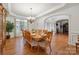Formal dining room with large table and hardwood floors, ideal for gatherings at 12004 New Bond Dr, Huntersville, NC 28078